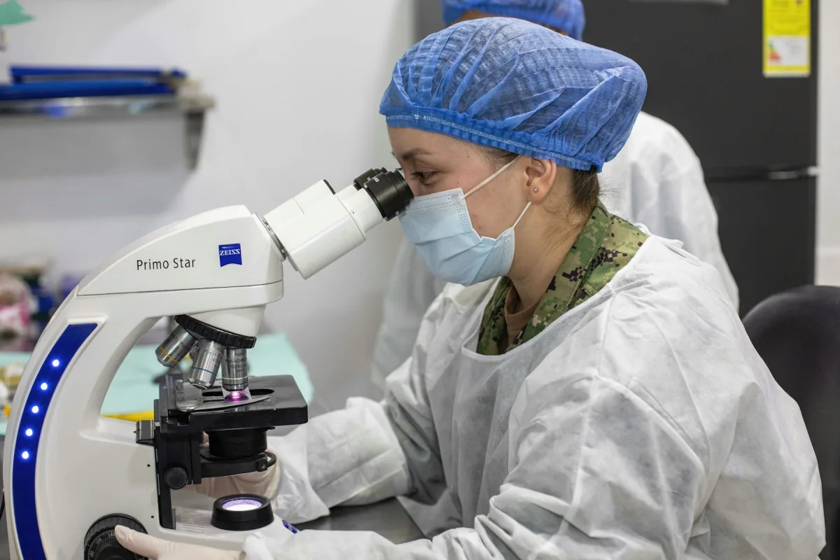 Scientist working with a microscope